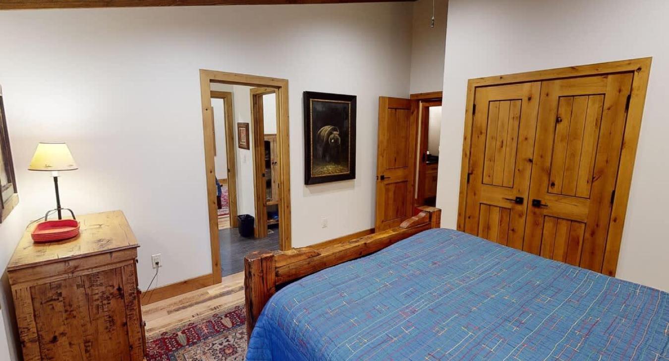 View of the hallway and connected bathroom from the third bedrooms bedside.