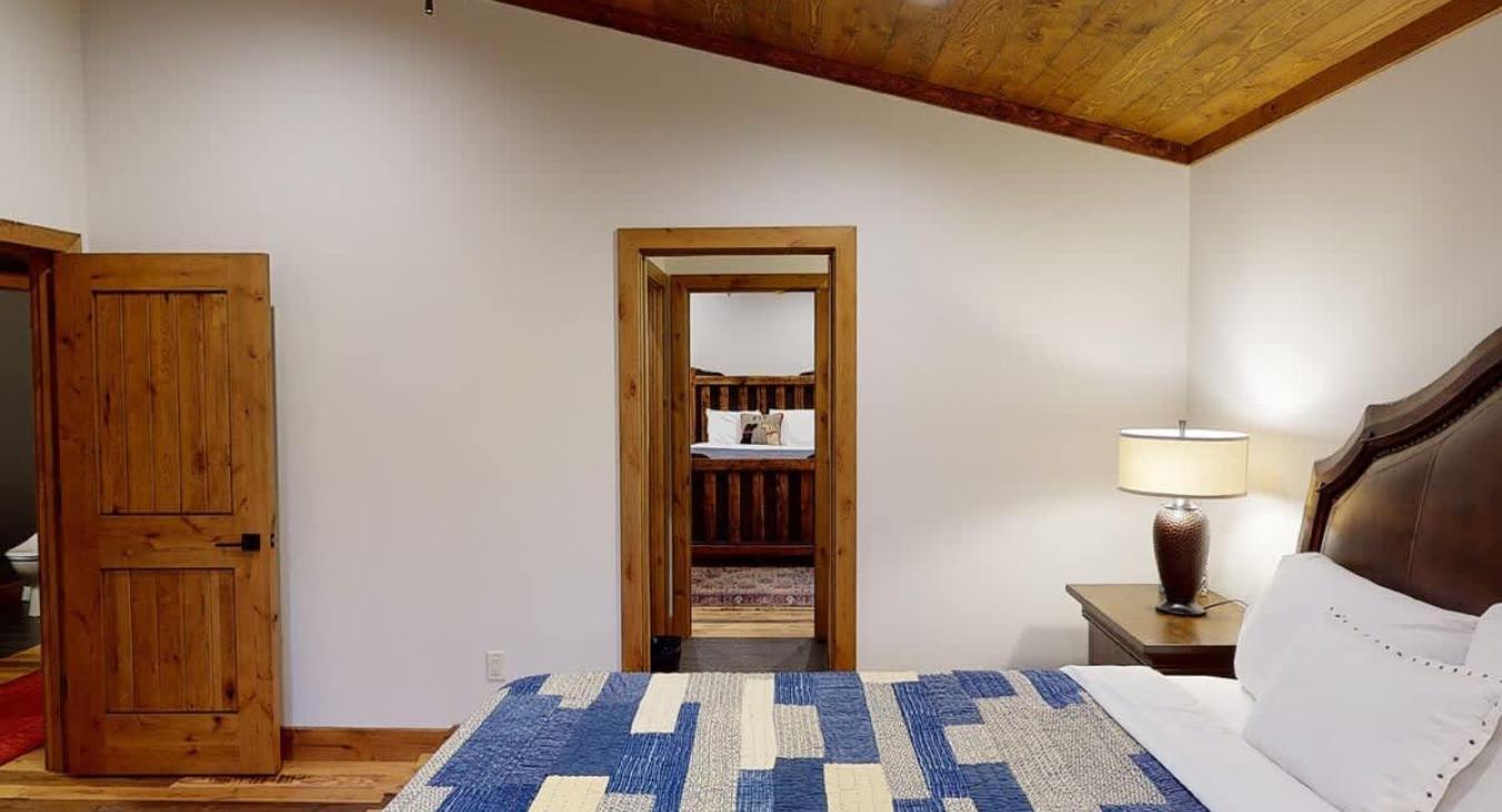 View of the shared Jack and Jill bathroom from the bedside in the second bedroom.