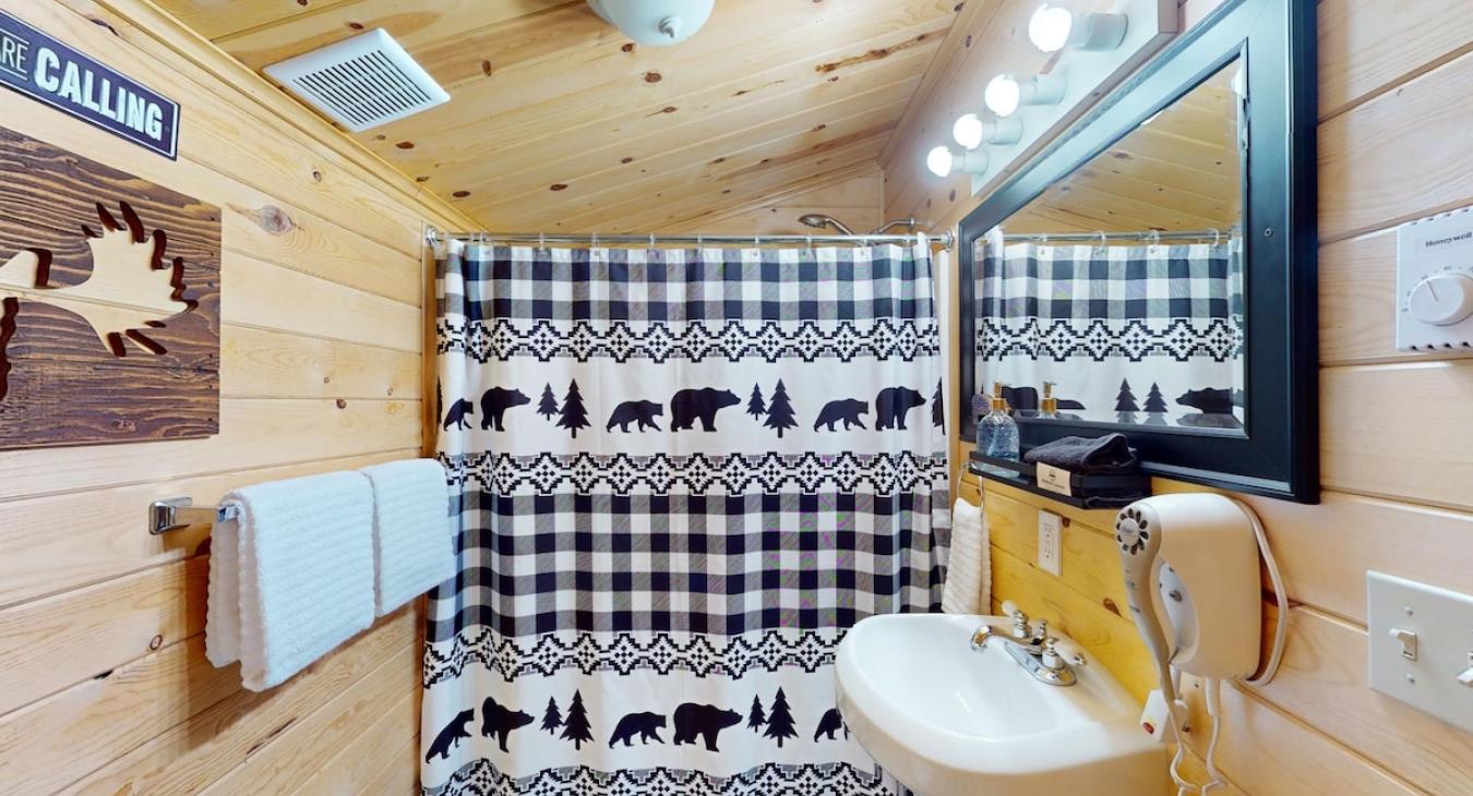 Full size bathroom with a shower tub combo, toilet, and sink.