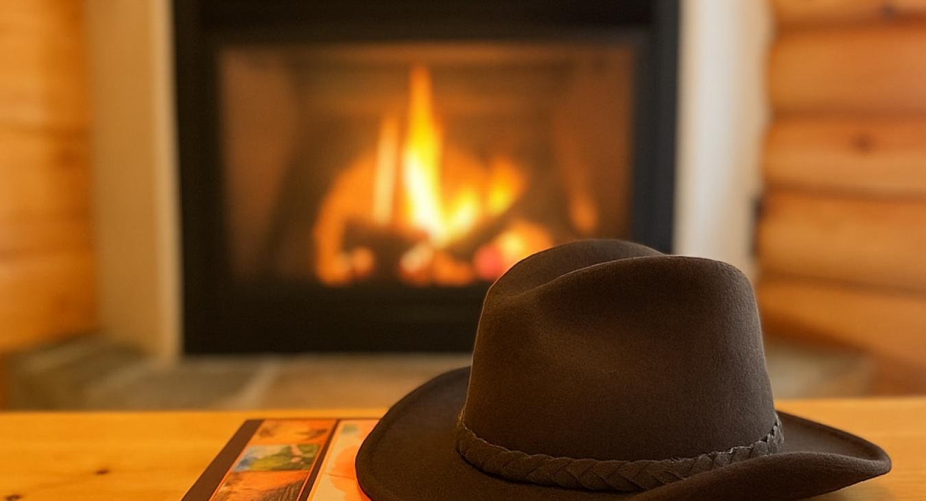 Relax while reading a book about Yellowstone National Park in front of the fireplace