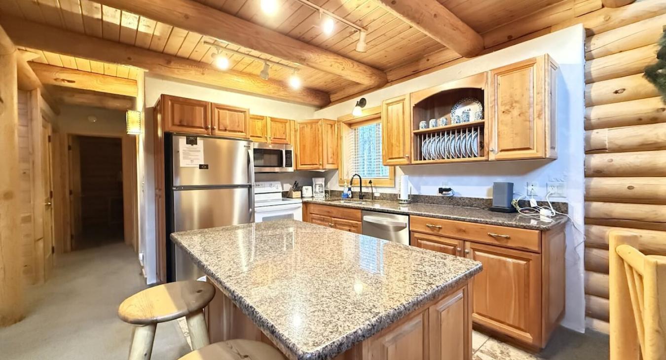 Very open kitchen with appliances, pots and pans, basic cooking essentials, dishes, and utensils.