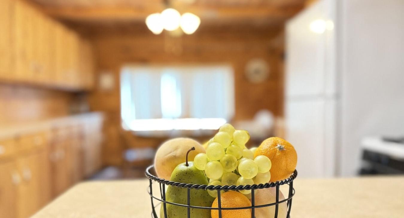 Fruit basket with view of the kitchen.