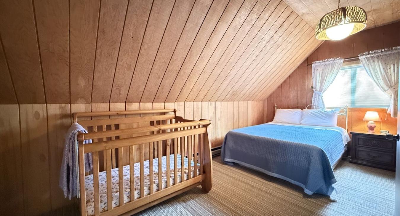 Upstairs bedroom with queen bed. Crib is also available to use.