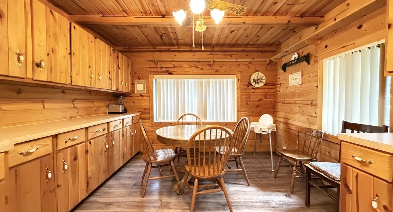 Dining room table located near the kitchen for easy access.