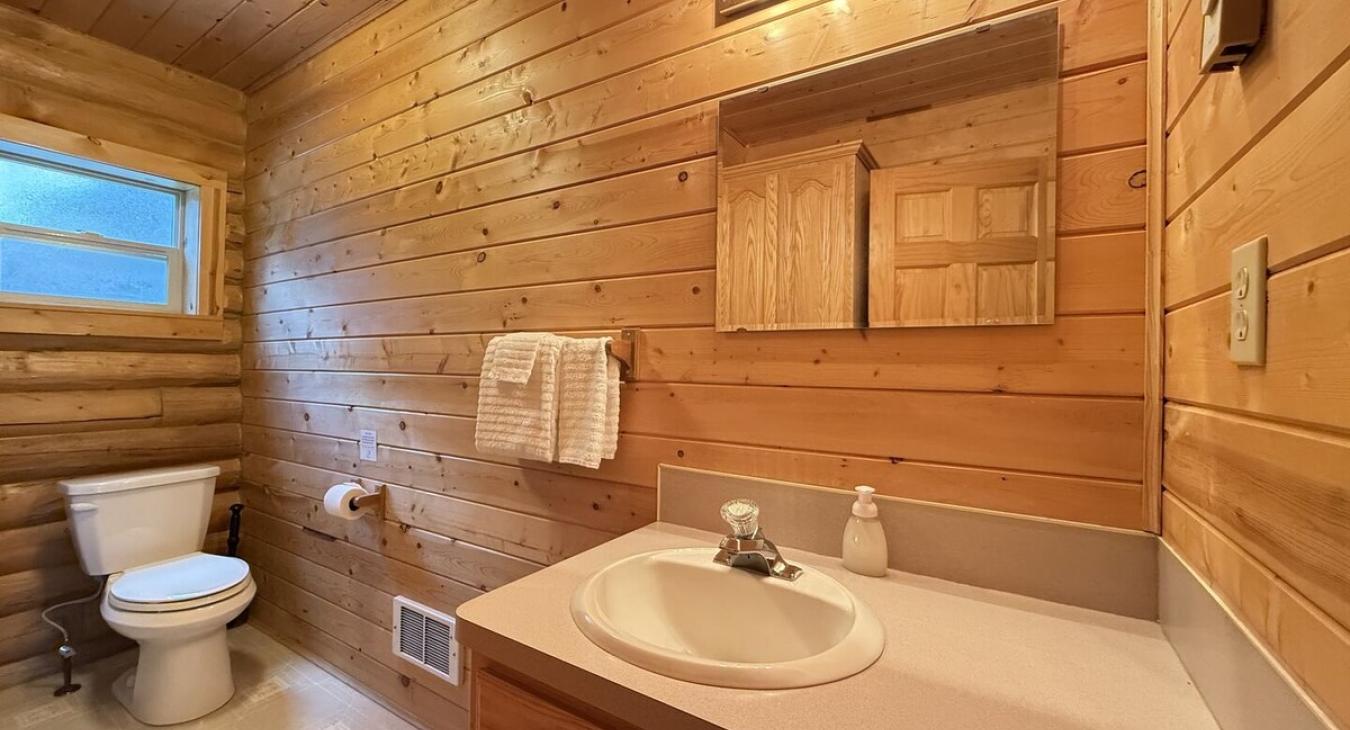 Upstairs bathroom with shower/tub, toilet, and sink.