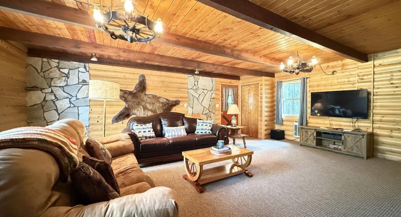 Living room on the main floor equipped with a fireplace and smart tv.
