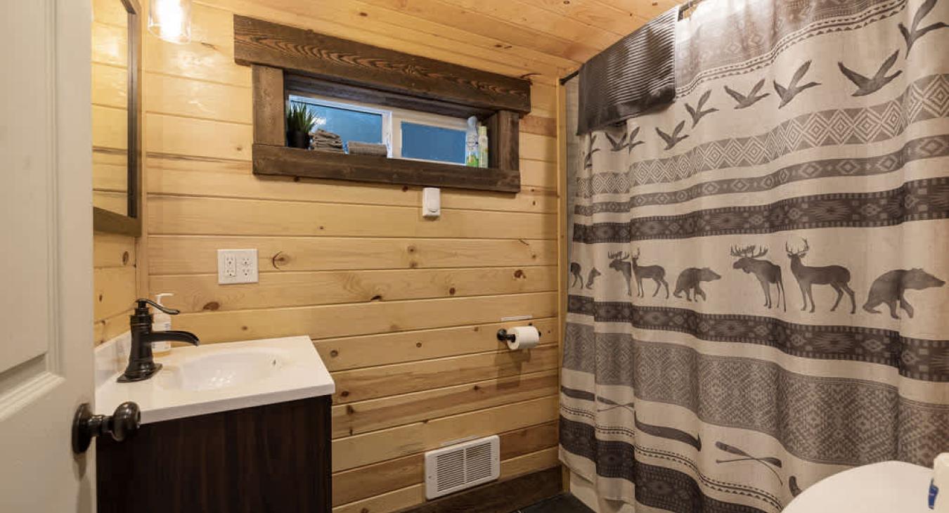 Full size bathroom with hot water on demand and a deep bathtub for soaking.