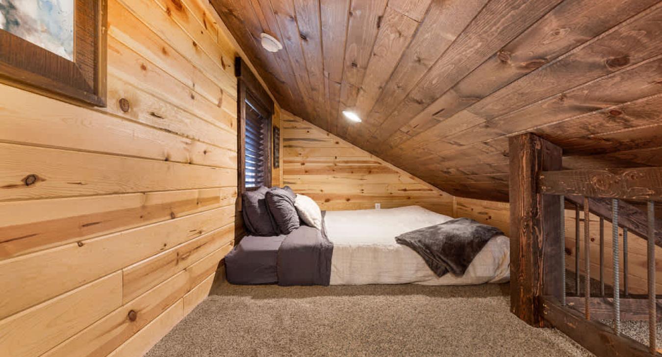 King bed in the open loft area.