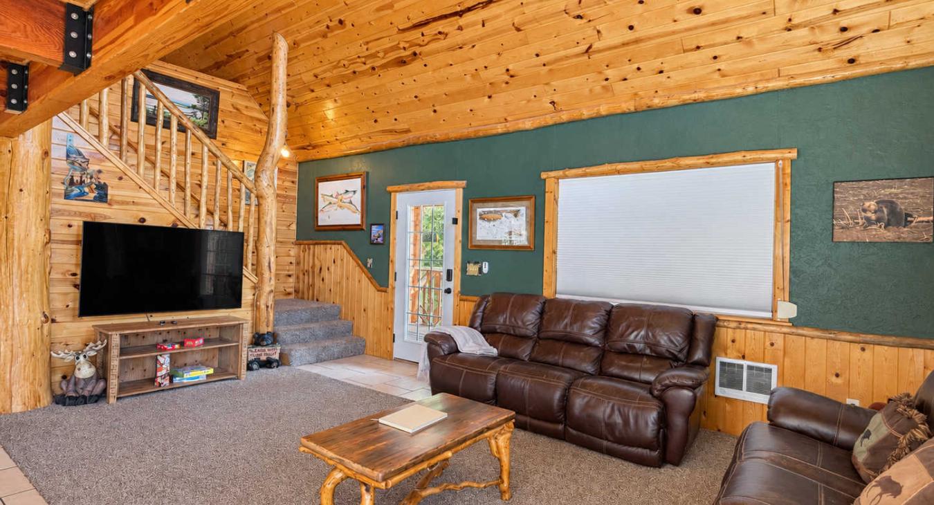 Open living room with a smart TV and games.