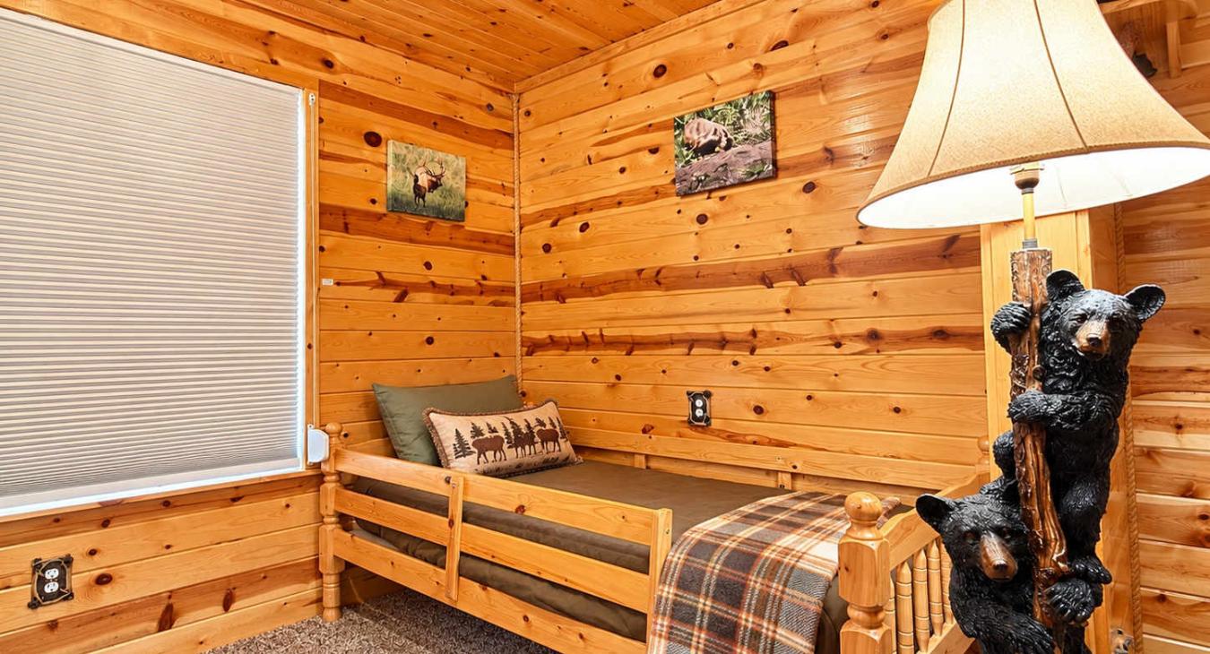This is a spacious bedroom on the main level with a queen bed and a nook with a twin bed.