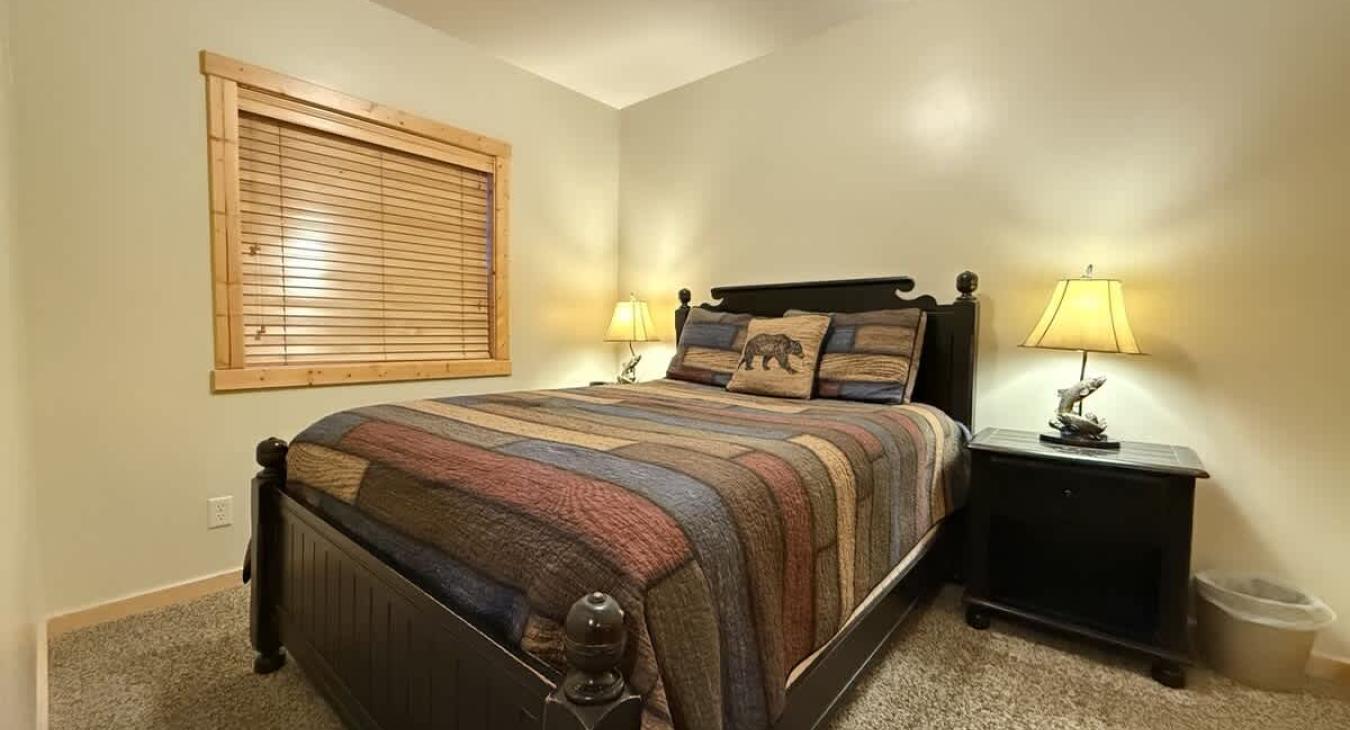 Bedroom #3 in the basement with a Queen size bed.