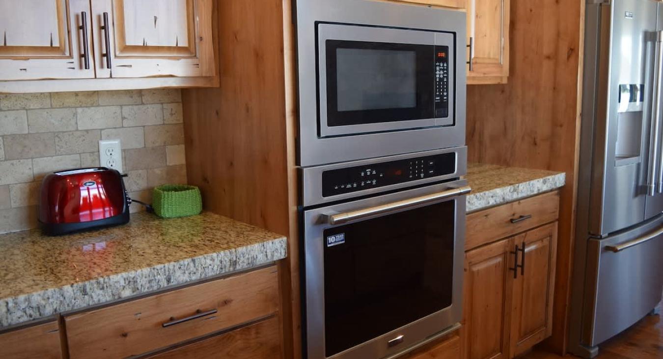 Basic cooking essentials with pots and pans, dishes, silverware, and small appliances.