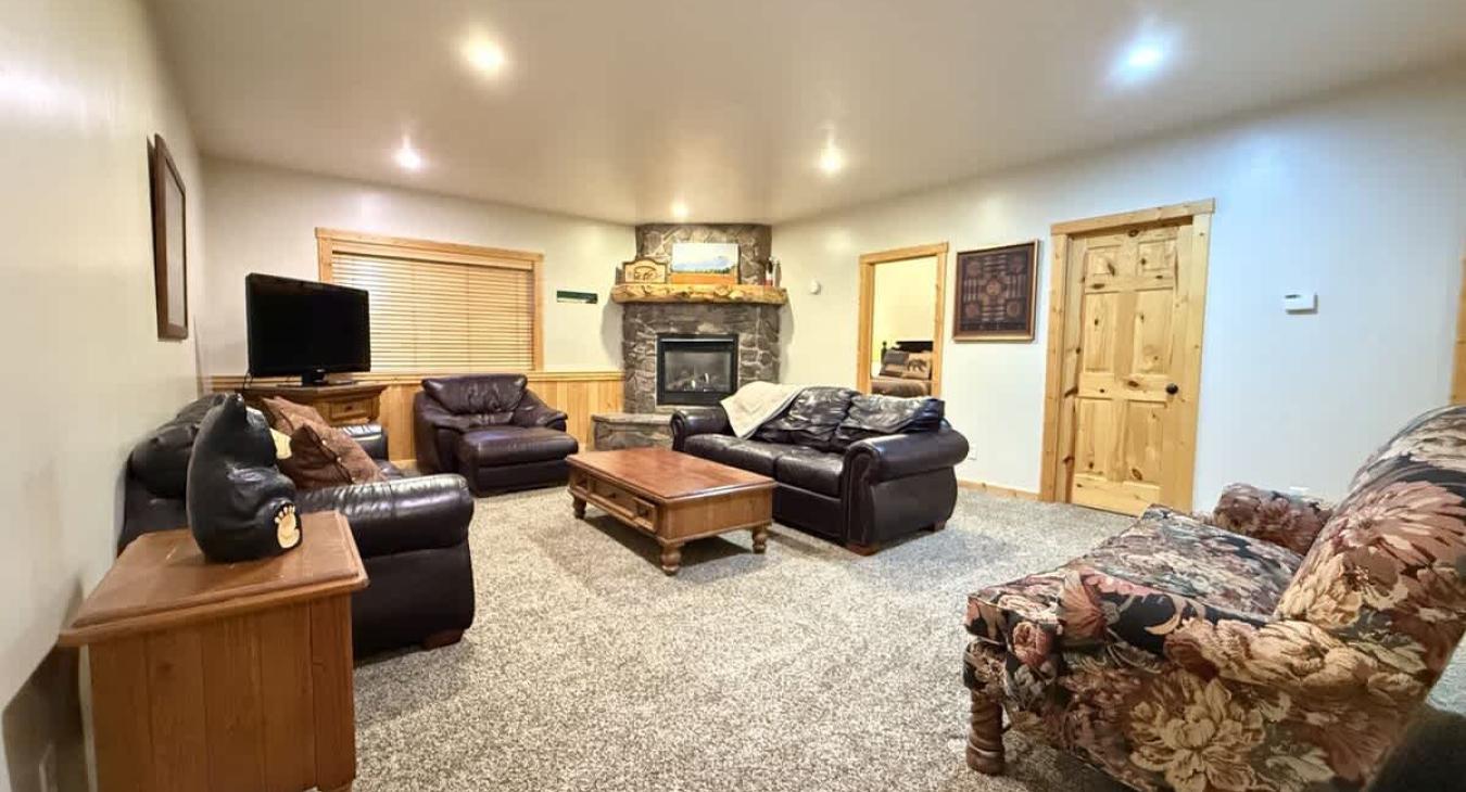 Relax after a long day in the living room that mixes both rustic charm and modern amenities.