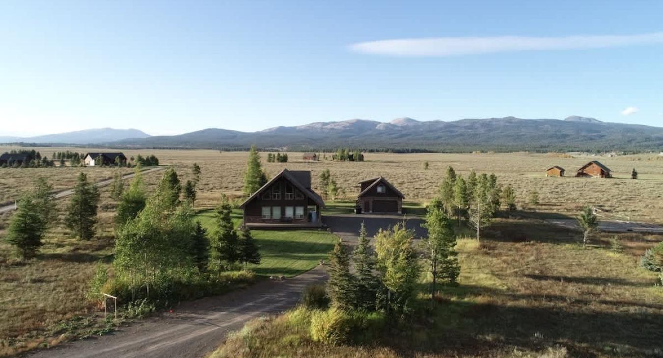 Imagine a cabin perched among the towering pine trees that give the area a secluded, forested feel.