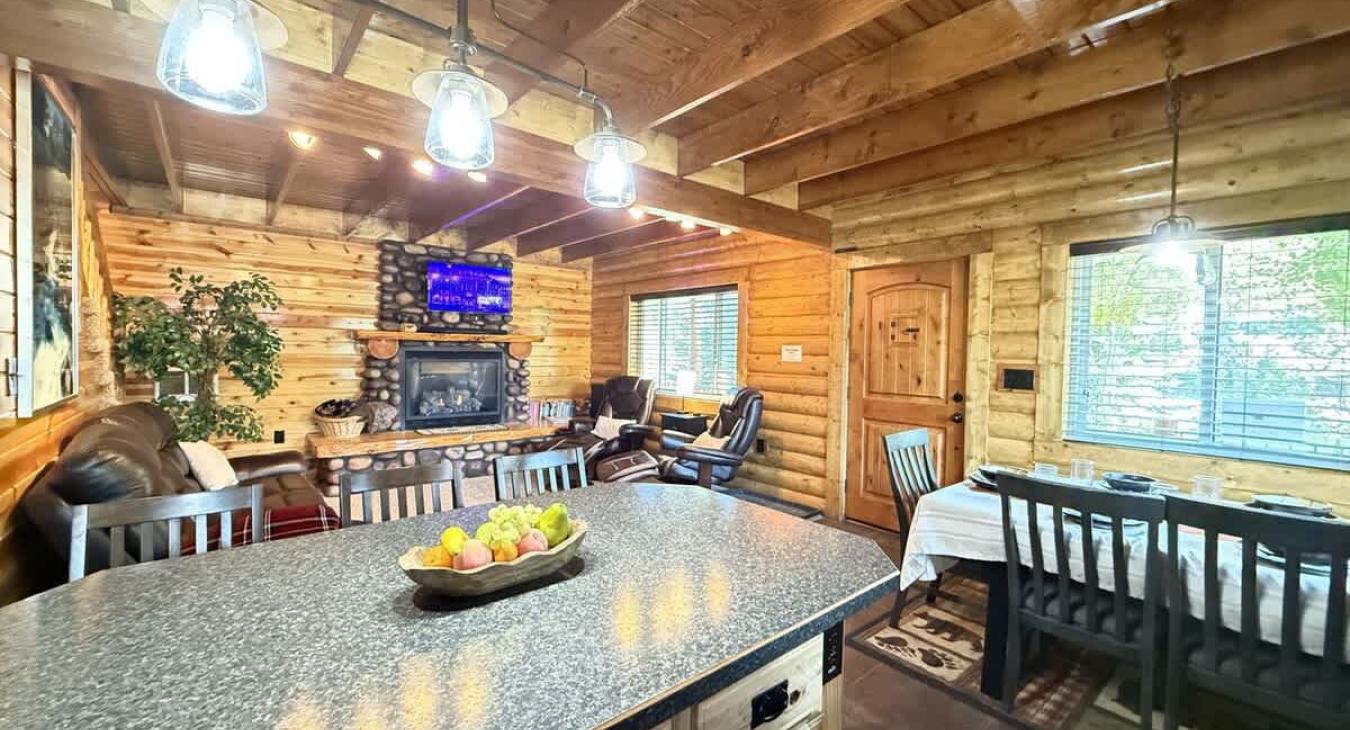 The open kitchen blends seamlessly into the cabin's cozy living area, creating a welcoming space perfect for gathering and unwinding.