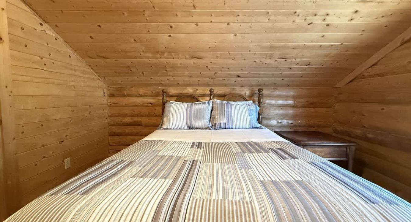 Bedroom #4 located upstairs with a Queen size bed.