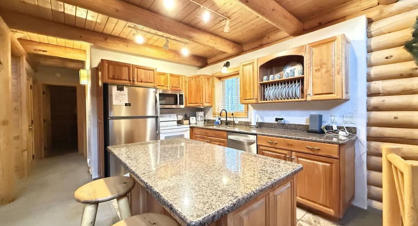 Very open kitchen with appliances, pots and pans, basic cooking essentials, dishes, and utensils.