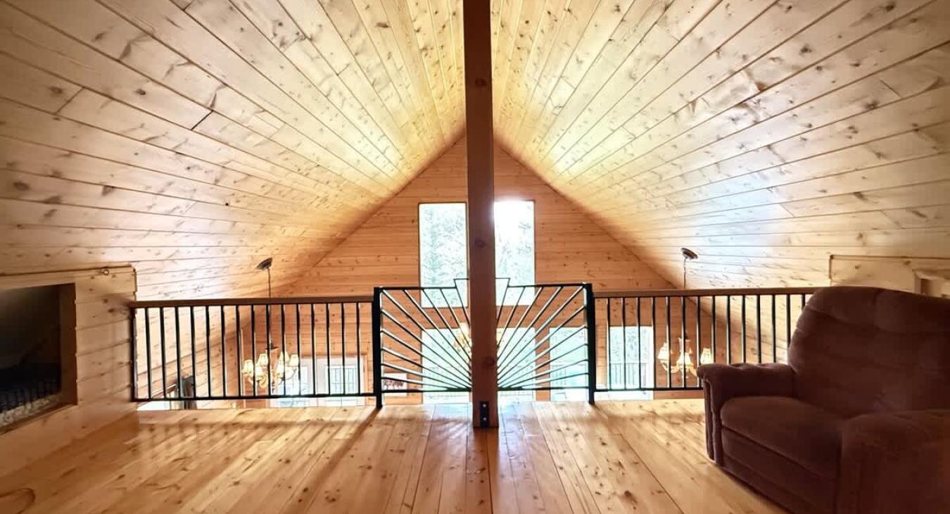 Loft with a chair and overlooks the main floor.