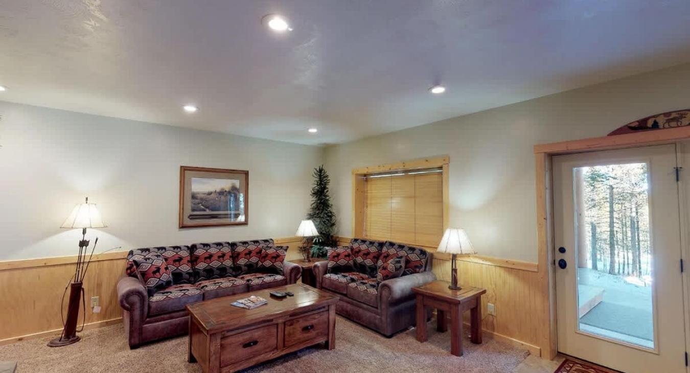 Living room area in the basement with seating.