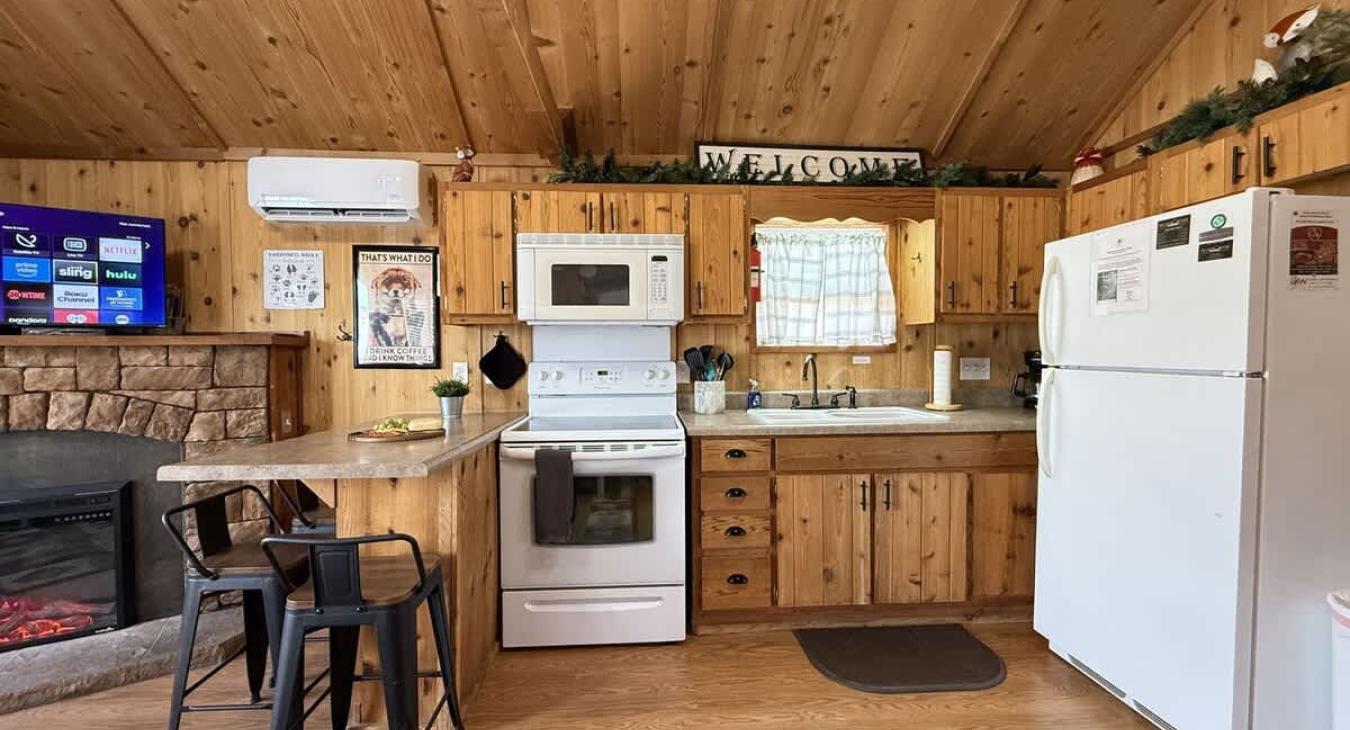 Full size kitchen with appliances, pots and pans, dishes, and cooking essentials.