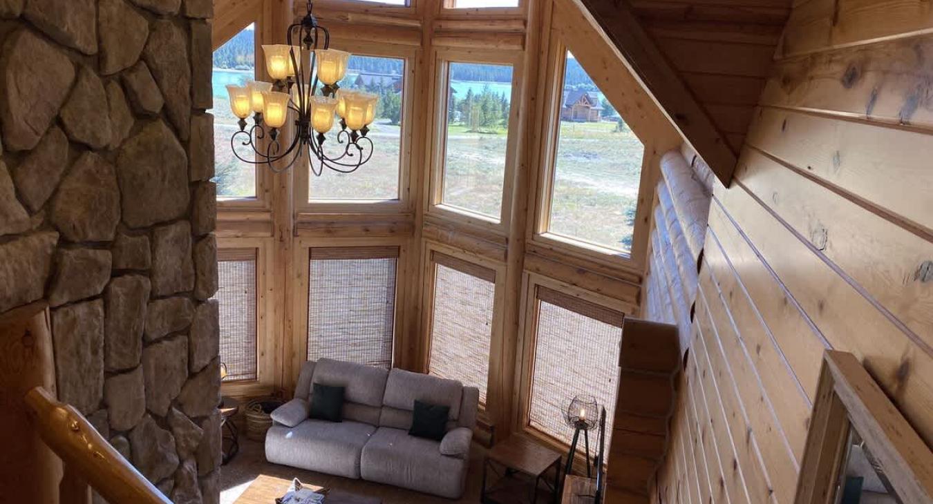 Upstairs from the loft there is a beautiful view of the living room with views of landscape from the large windows.