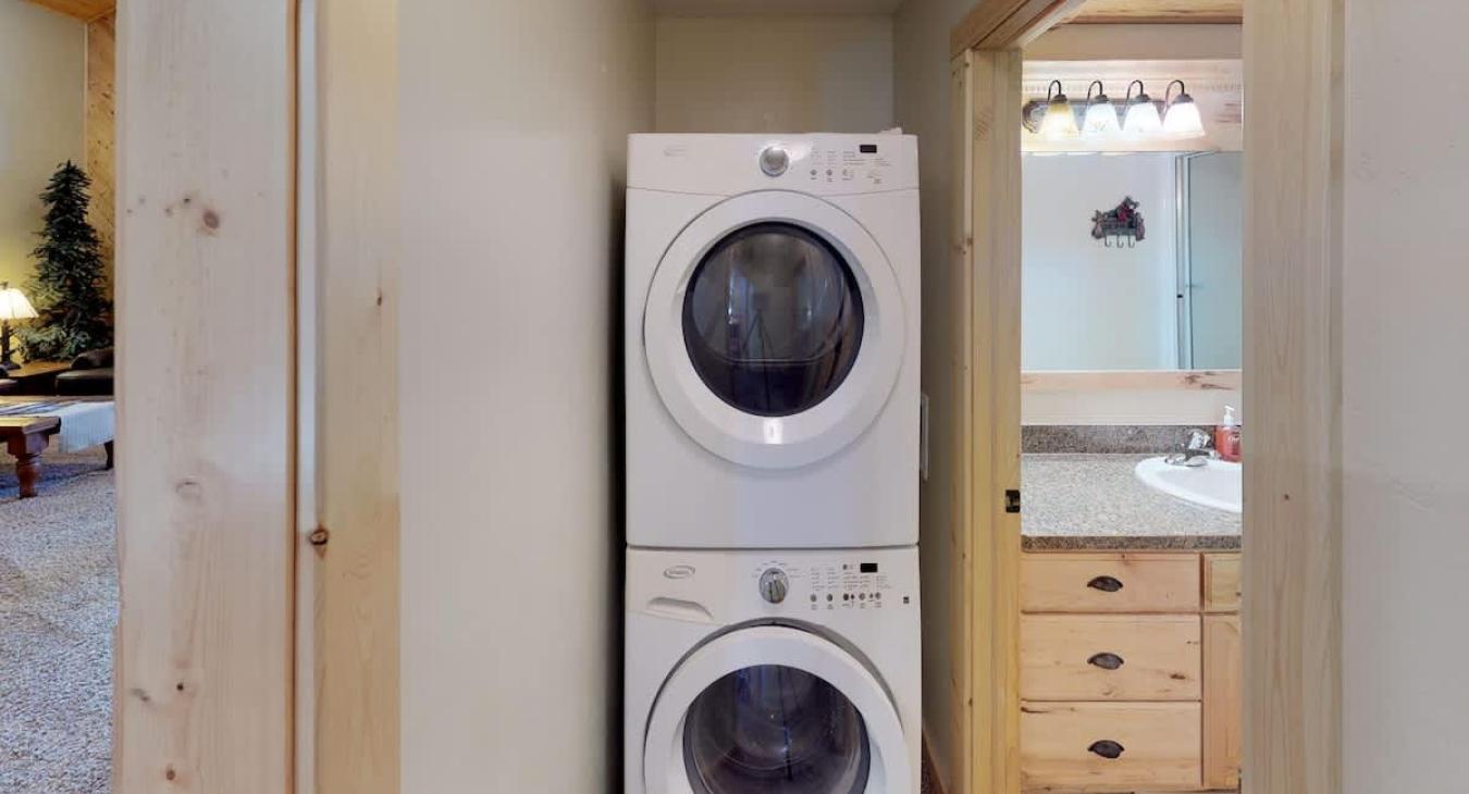 Outside of the bathroom is a stacked washer and dryer for your use. Laundry soap is provided.