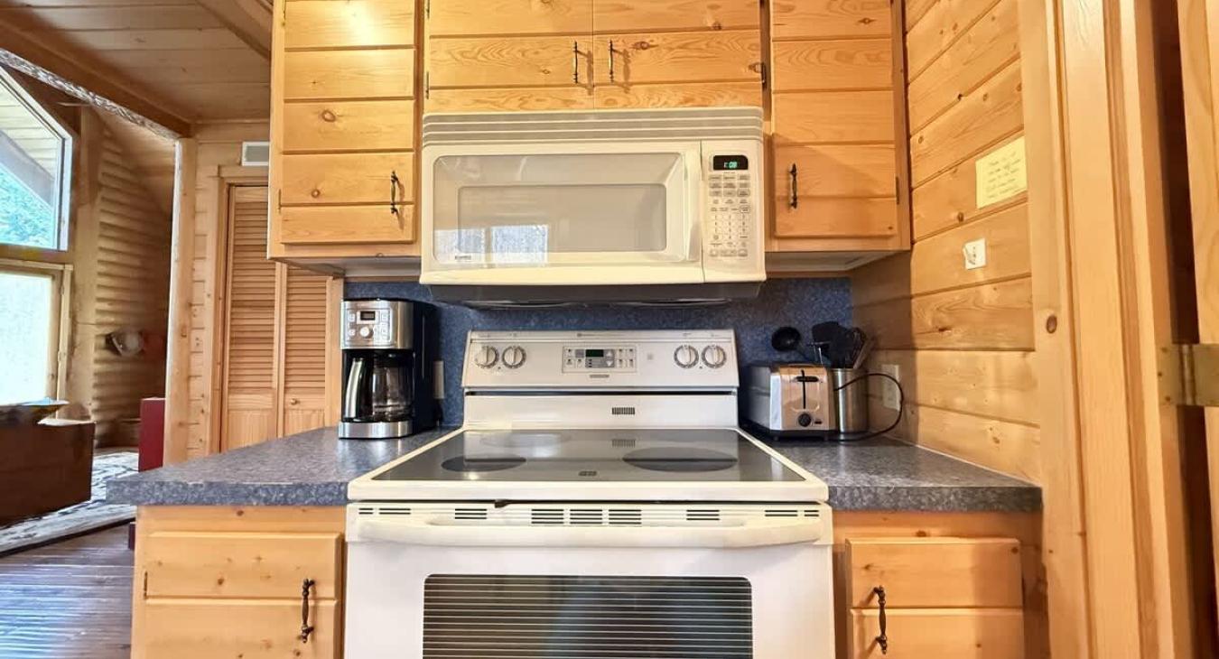 Full size kitchen with appliances, pots and pans, dishes, utensils, and basic cooking essentials.
