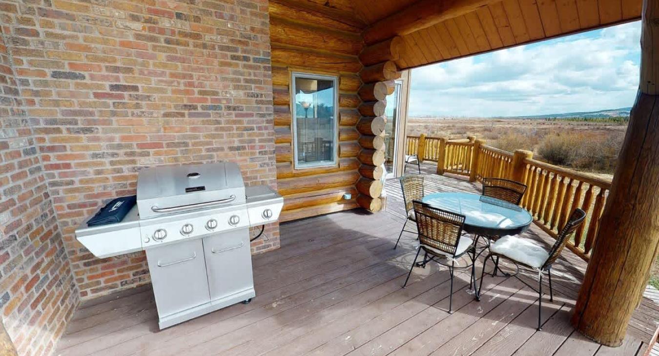 Outside deck with a grill and seating.