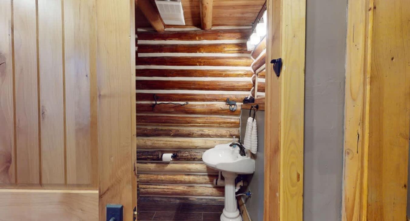 Half bathroom with toilet and sink on the main level.