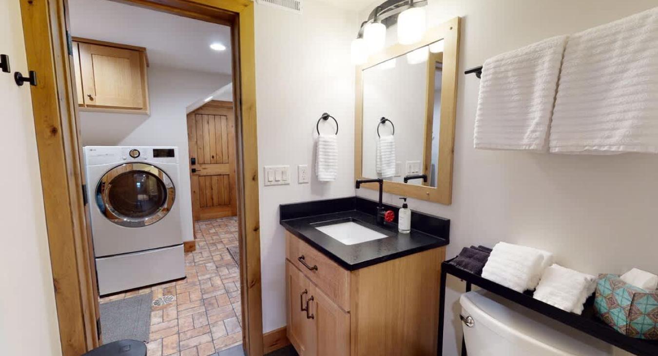 The bathroom vanity with a glimpse into the laundry room.