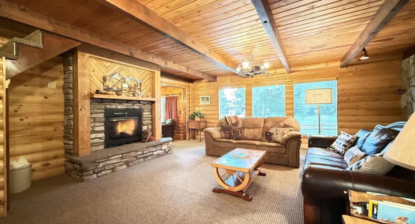 Living room on the main floor equipped with a fireplace and smart tv.