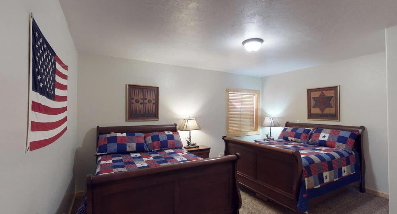 Bedroom #3 located downstairs in the basement. Equipped with 2 Queen beds, perfect for 4 people.