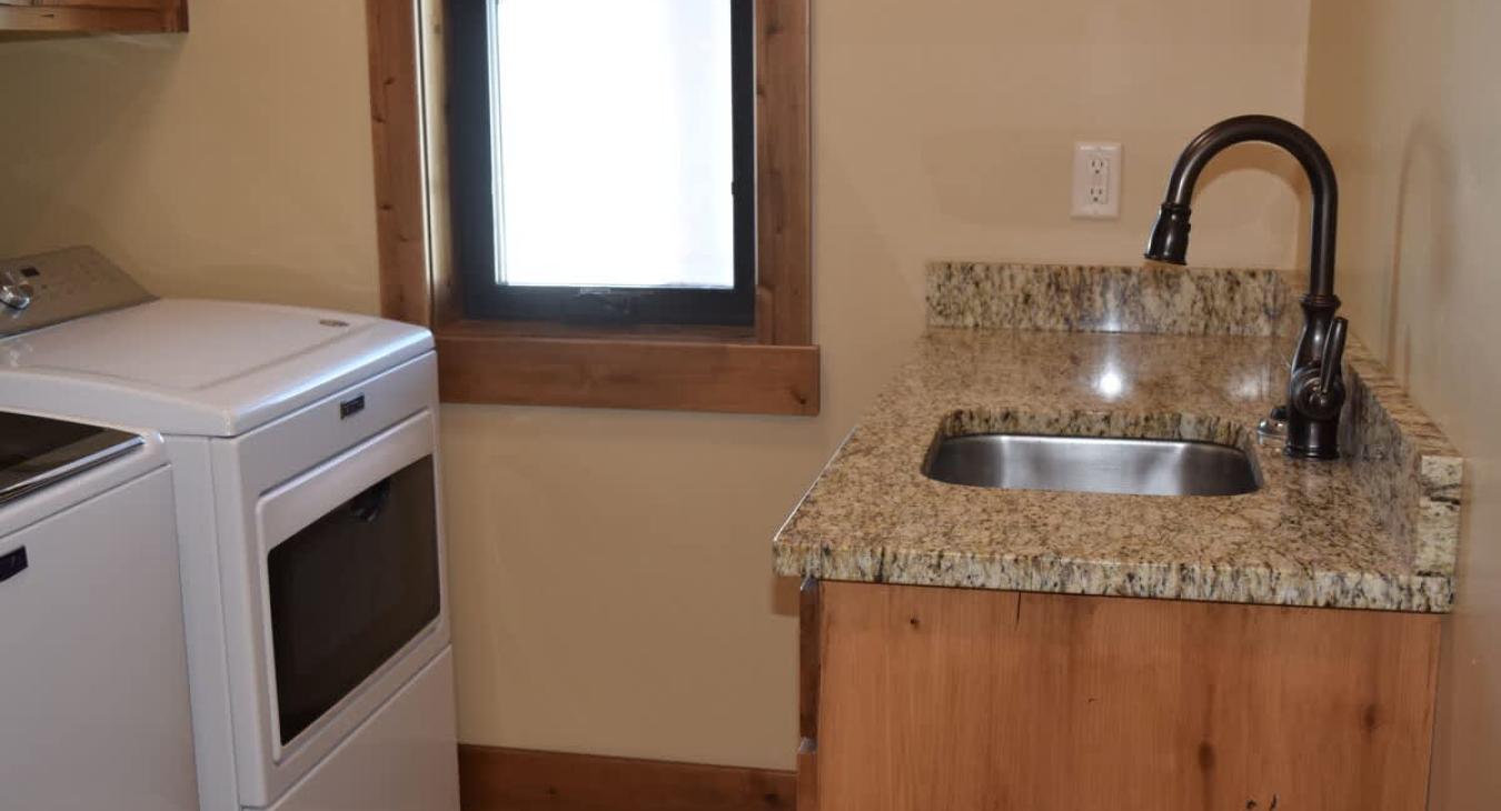 Laundry room with washer and dryer. Laundry soap is provided.