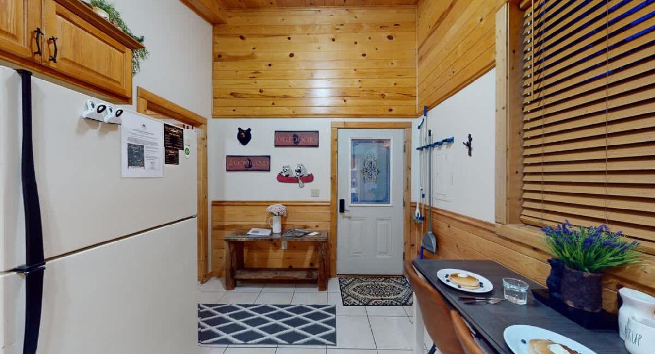 The entryway to the cabin leads you right into the kitchen and the bedroom to the right.