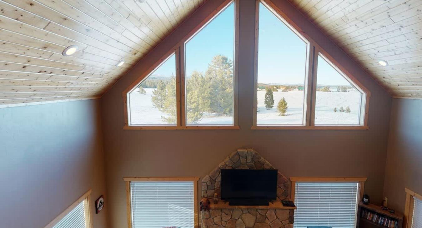 Natural light pours in through large windows, tying it all together with a view of the forest just beyond.