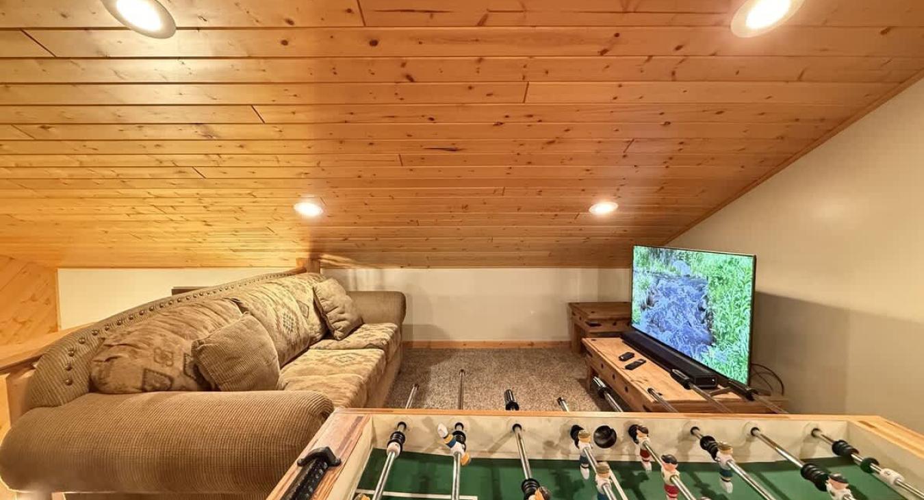 In the loft sits a solid foosball table—wood finish to match the cabin vibes, but sturdy enough for serious tournament play.