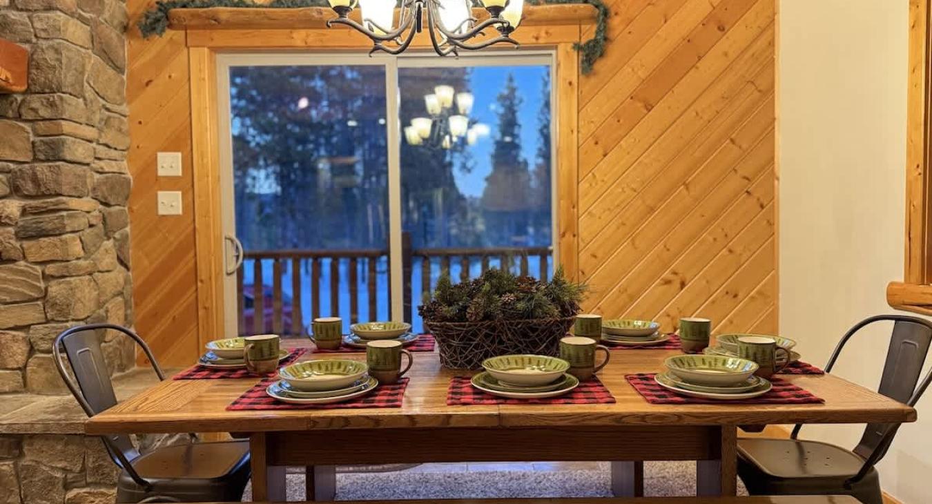 Dining table located across from the kitchen with seating for up to 8 people. Additional seating is also available at the island with 4 more seats.