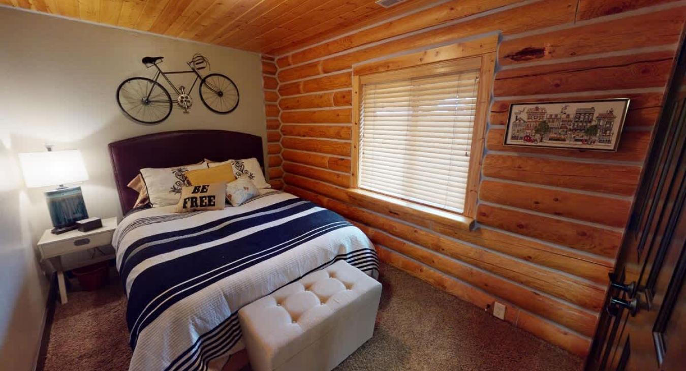 Bedroom 2 located upstairs with a Queen size bed.