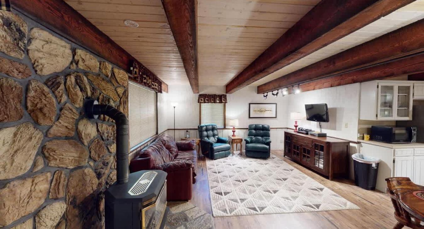 Large open living room with seating and a tv for entertainment.