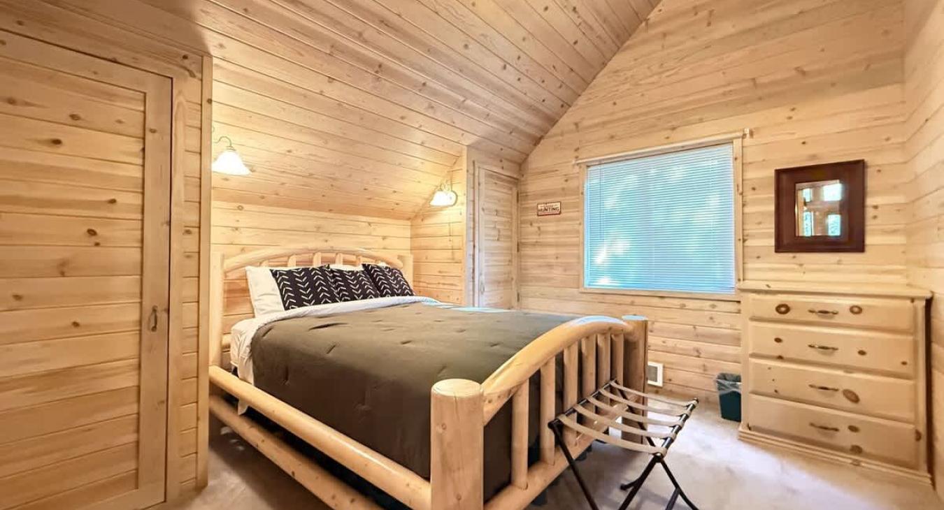 Queen size bed with dresser for storage.