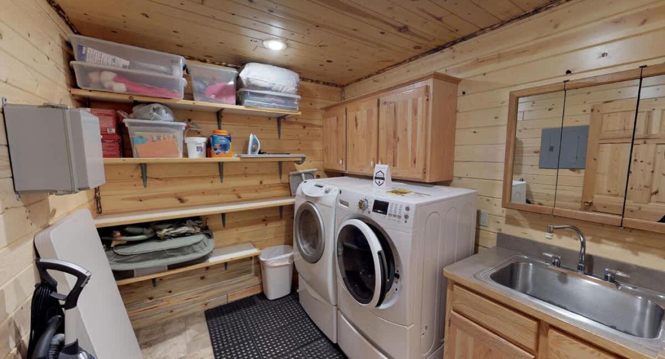 Mud room with full size washer and dryer. Laundry soap is provided.