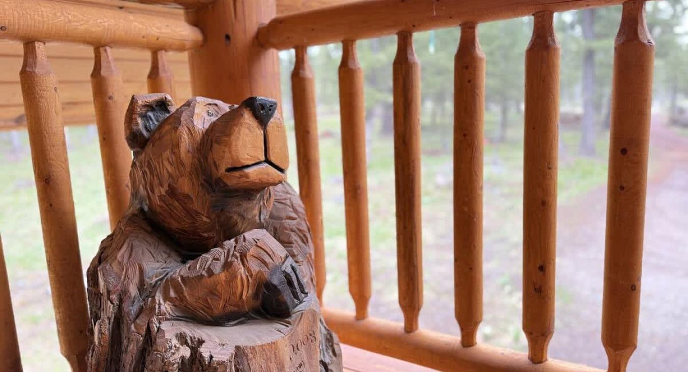 Carved bear on the balcony overlooking driveway