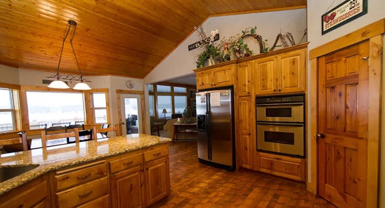 Kitchen equipped with stainless steel appliances, pots and pans, and basic cooking essentials.