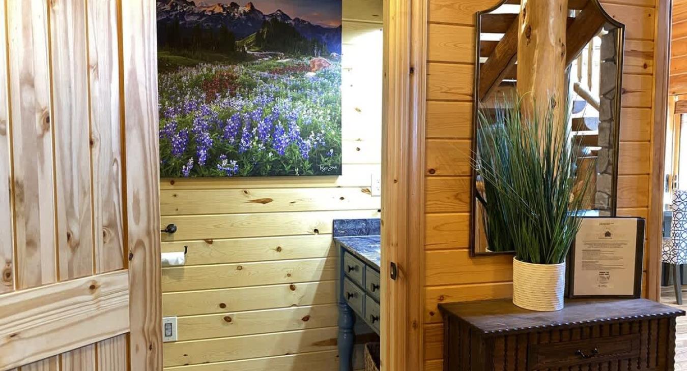 Imagine stepping into a cozy half bathroom in a cabin, designed to blend rustic charm with functionality.