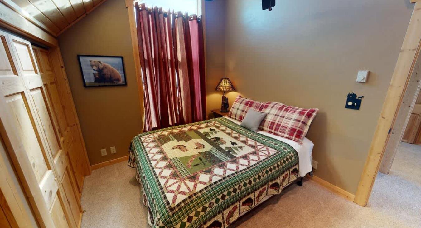 Bedroom #3 located upstairs with a Queen size bed.