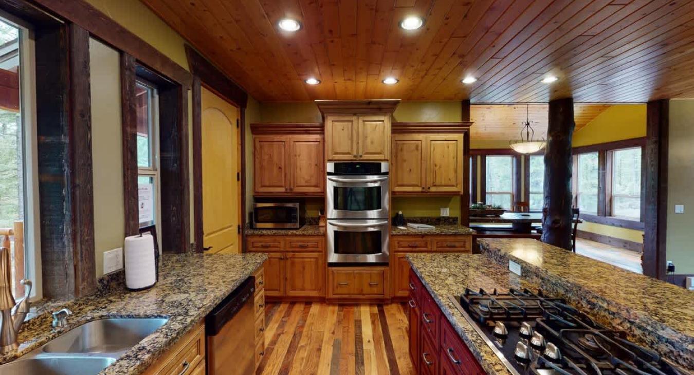 Full size open kitchen equipped with everything such as appliances, cookware, pots and pans, utensils, dishes, and basic cooking essentials.