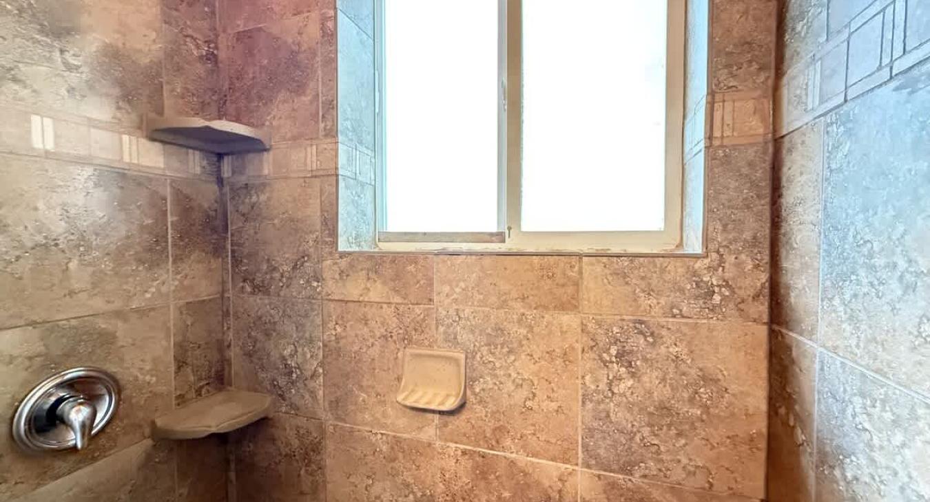 Walk in tiled shower.