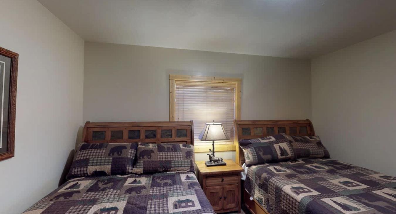 Bedroom #5 located in the basement with 2 Queen size beds.