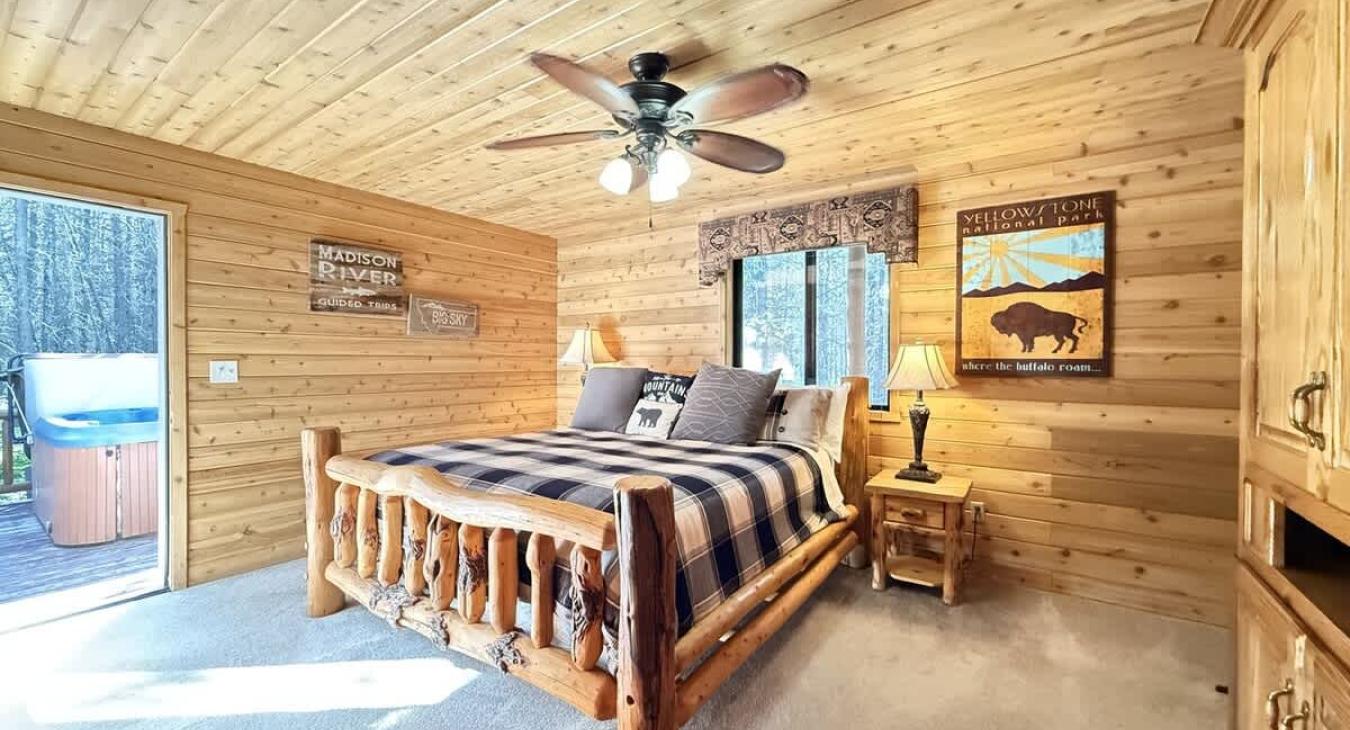 Master bedroom furnished with end stand tables, lamps, and a luggage rack.