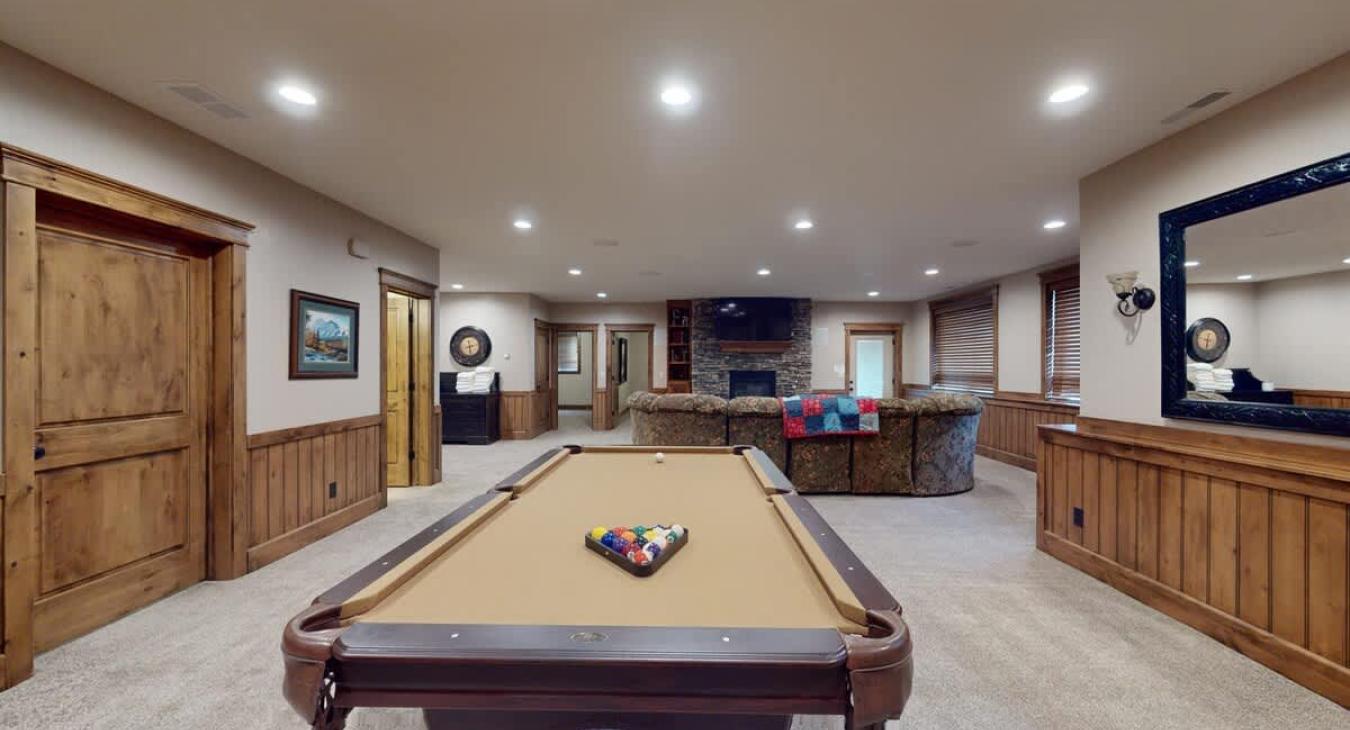 Basement living area with a pool table.